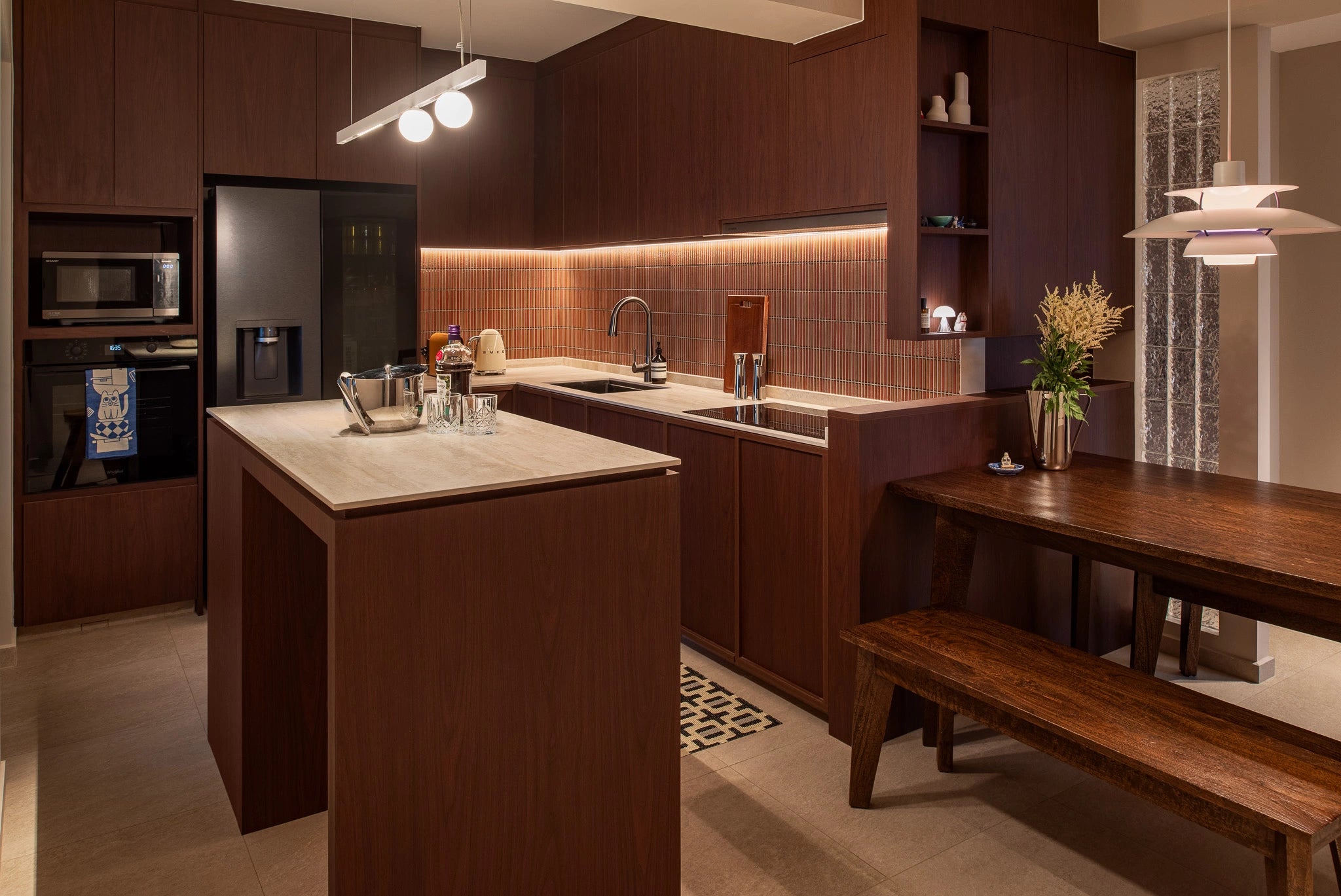 Mid-century modern kitchen with wooden table, red backsplash tiles, and stone countertop