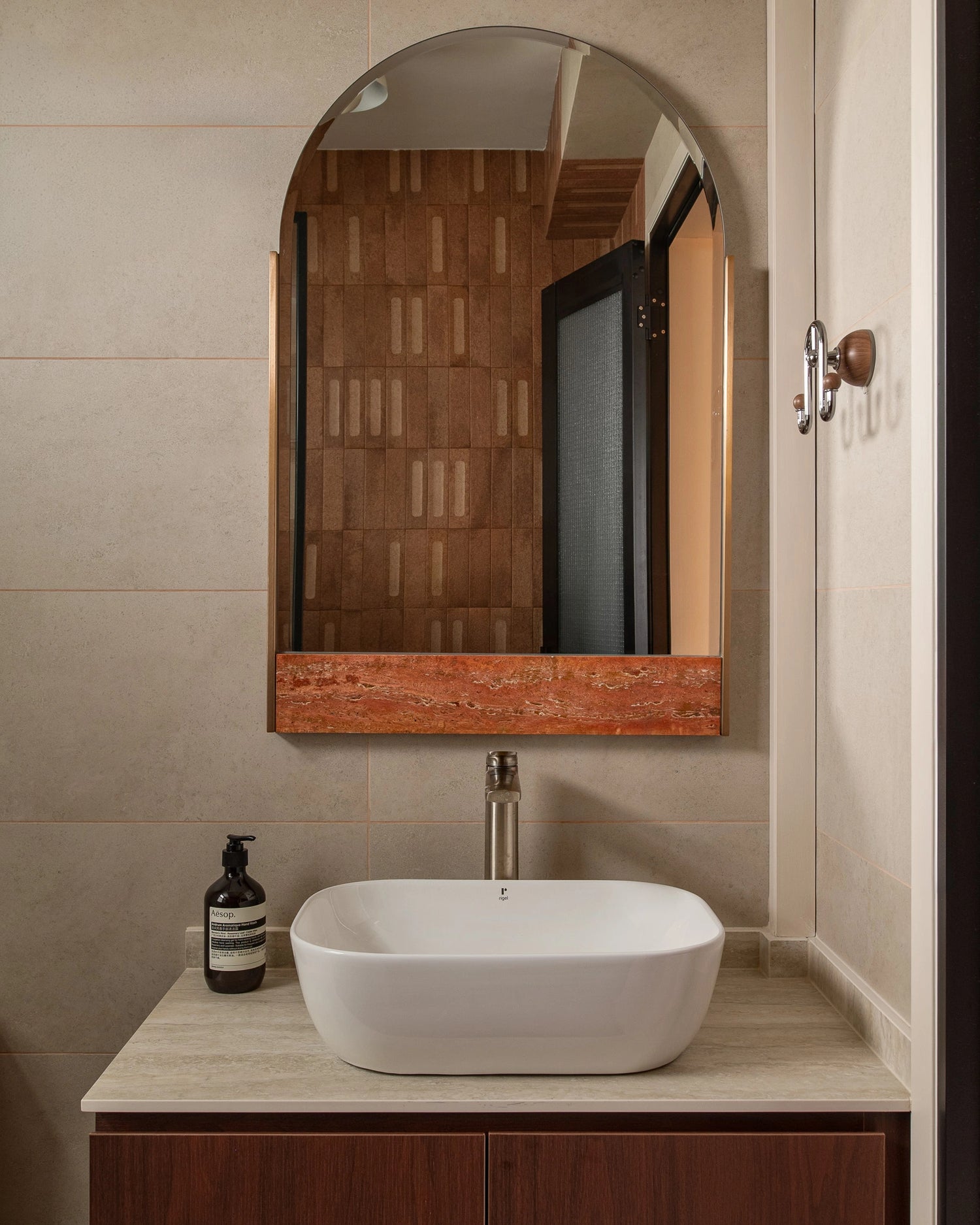 Mid-century modern bathroom with countertop basin and red marble accent mirror