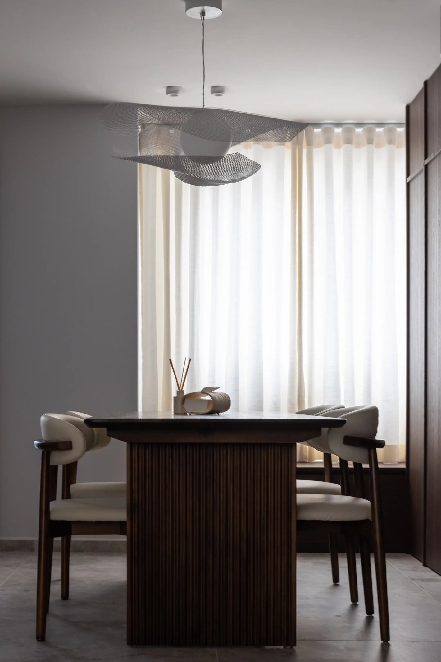 Mid-century modern dining room with pendant light and full-height cabinetry