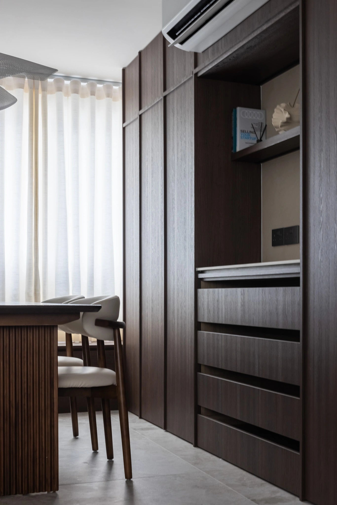 Mid-century modern dining room with pendant light and full-height cabinetry