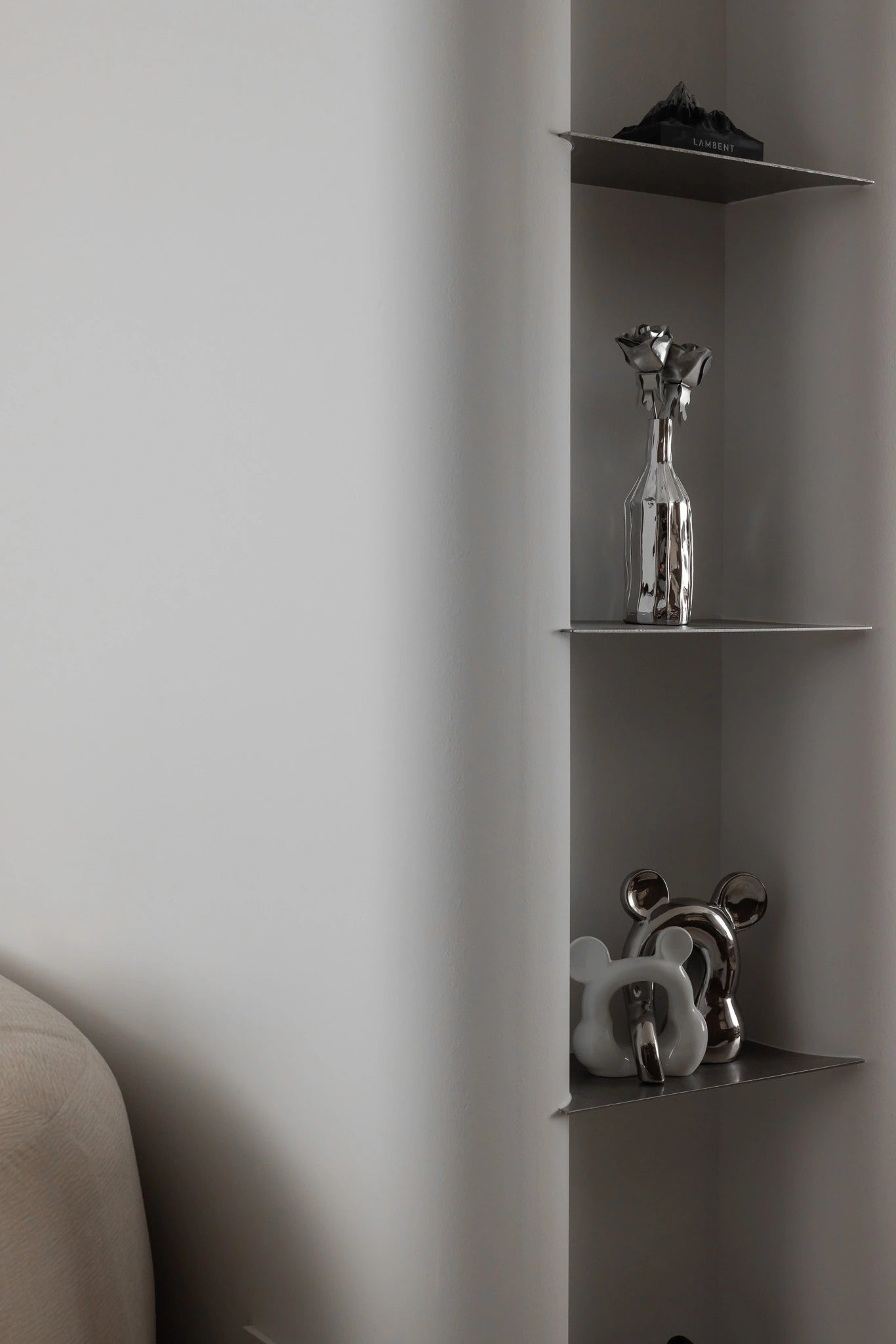 Modern living room with stainless steel shelving and silver decor