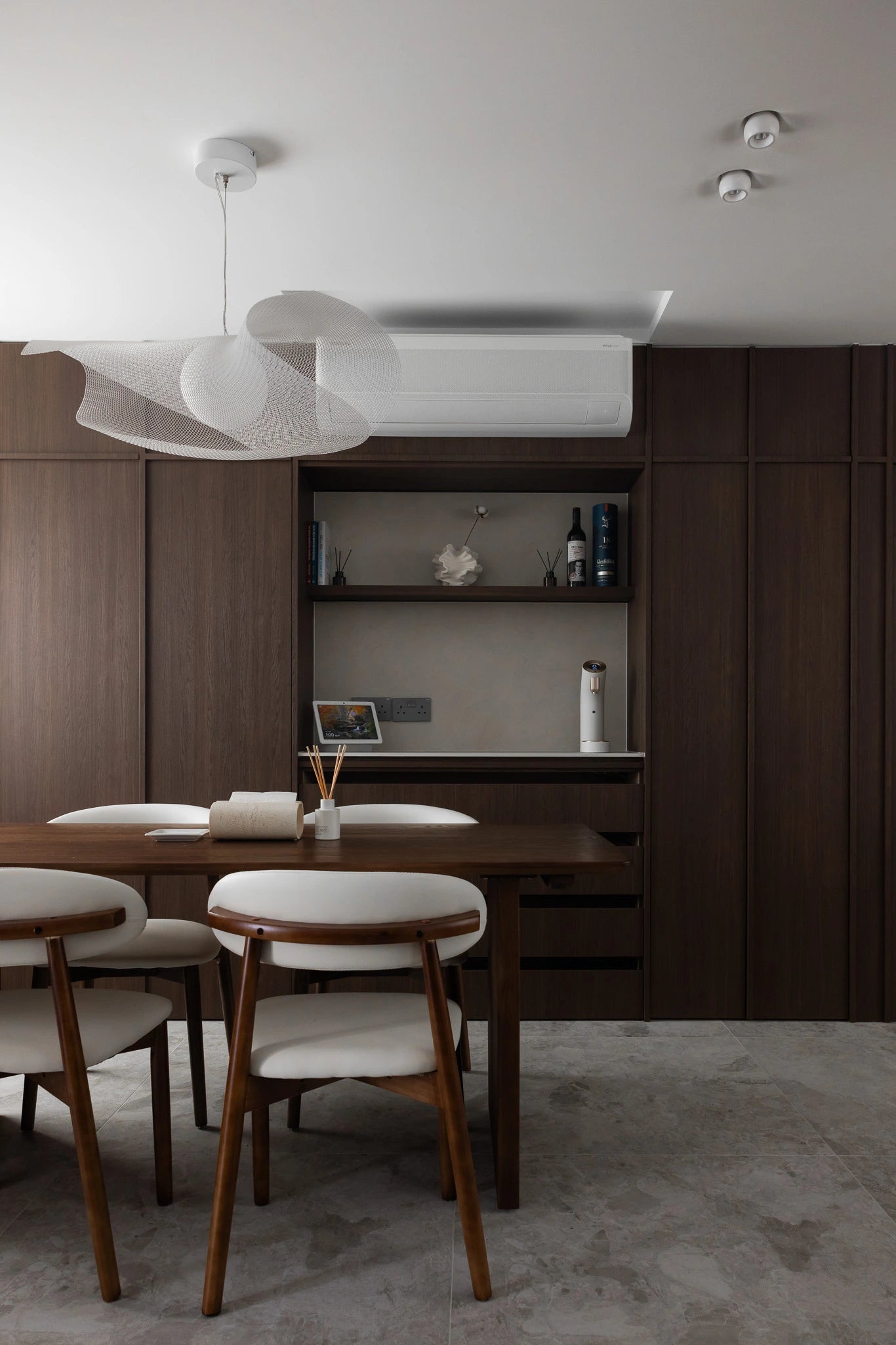 Mid-century modern dining room with pendant light and full-height cabinetry