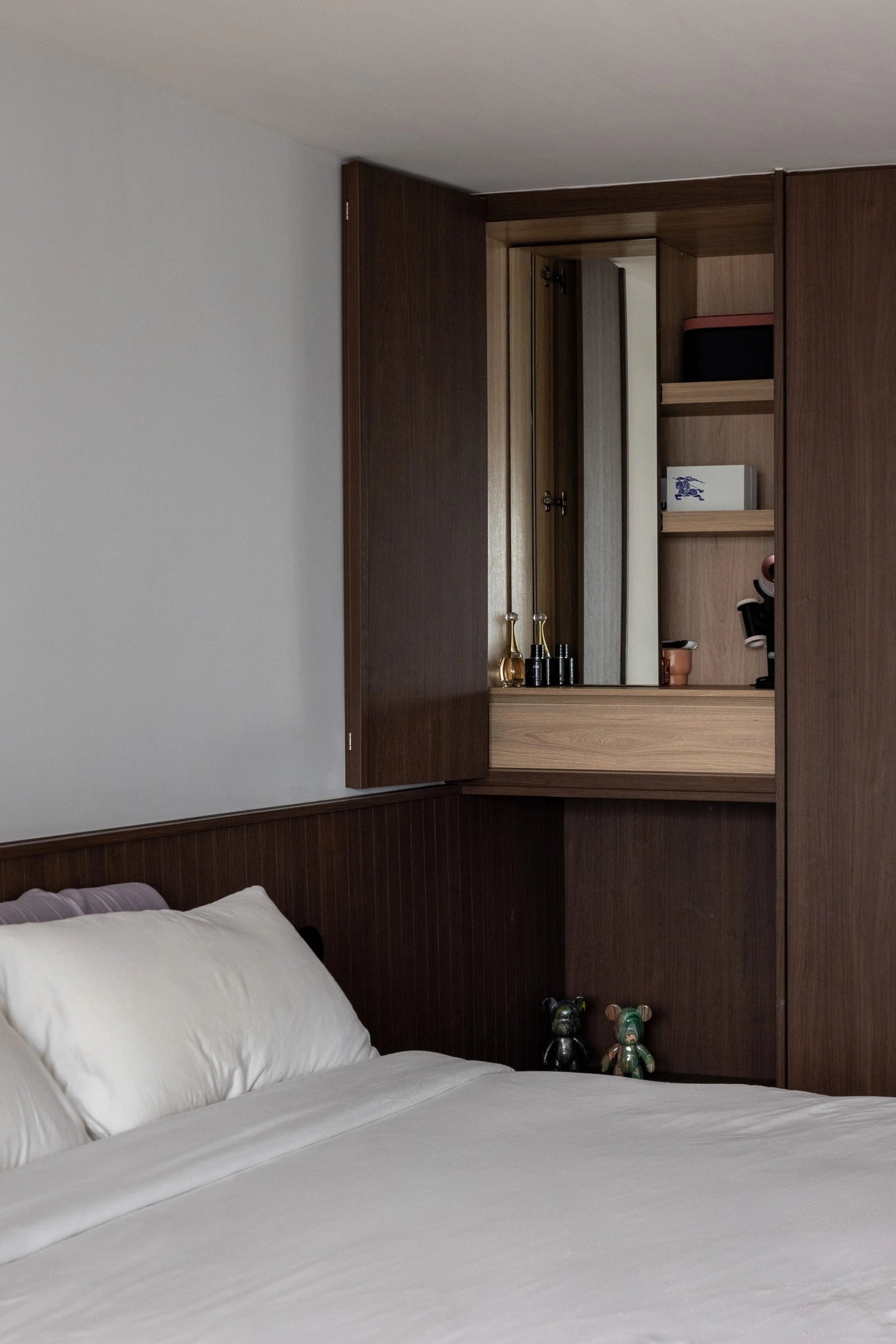 Mid-century modern bedroom with hidden vanity in custom cabinetry
