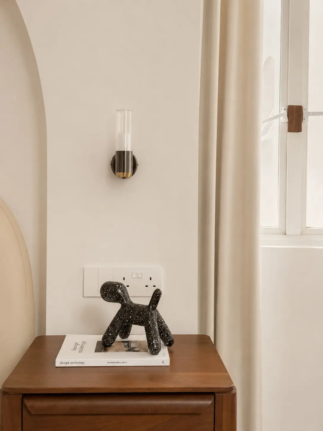 Minimalist bedroom with an arched feature wall and wall sconces