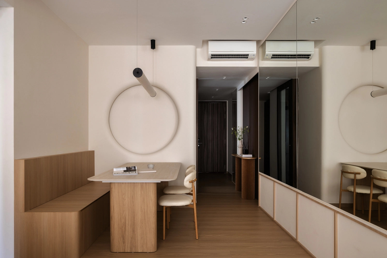 Scandinavian dining room with large mirror, wooden furniture, and pendant light
