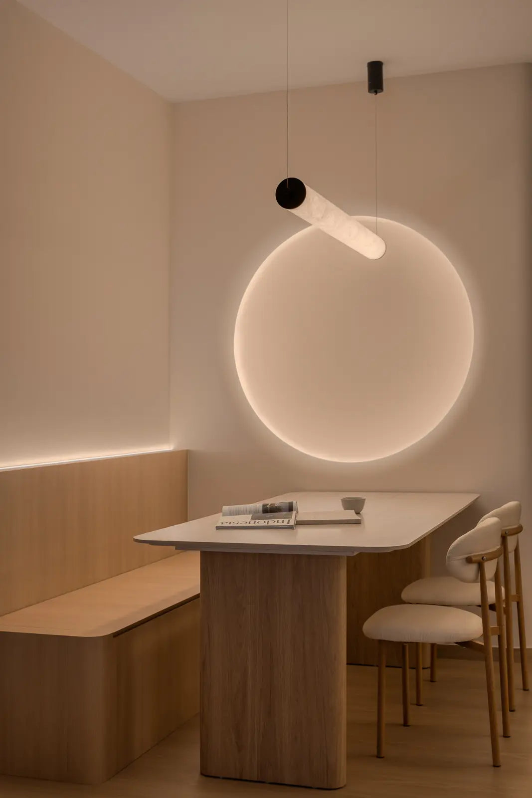 Scandinavian dining room with statement round light and pendant light